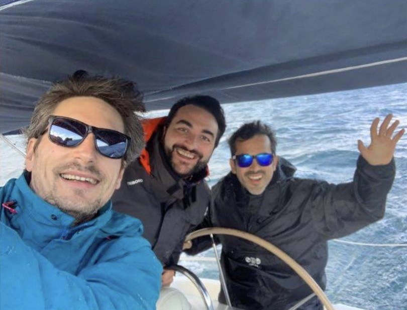 A skipper at the helm of a sailing yacht off Puerto Banús, Marbella