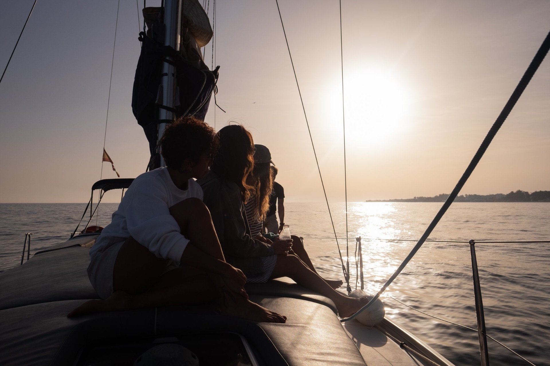 Guests relaxing on deck at golden hour during a sunset sail off Puerto Banús, Marbella