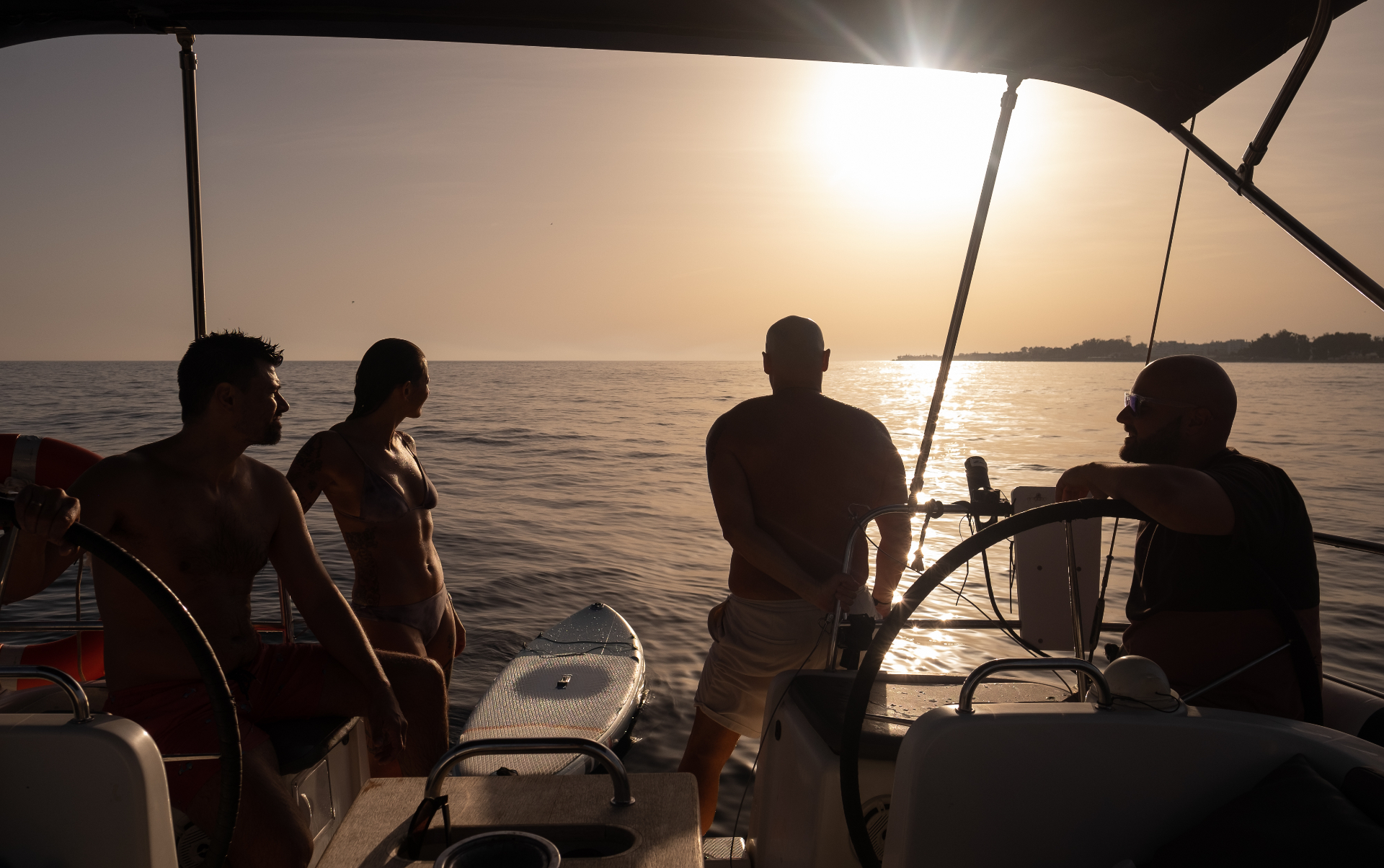 Friends watching the sunset on a sailing yacht off Puerto Banús, Marbella — golden-hour sail with Veleros Marbella