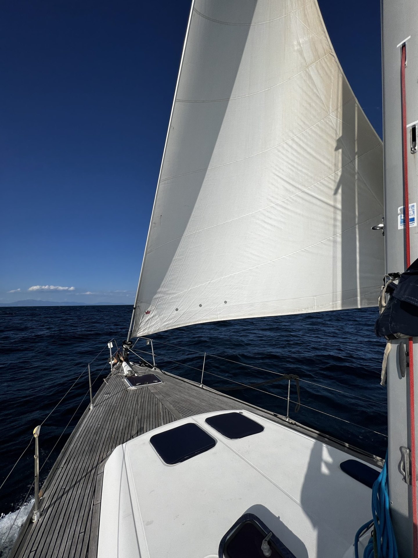 Nirvana, a Dufour 455 sailing yacht, under sail off Marbella — view down the teak deck
