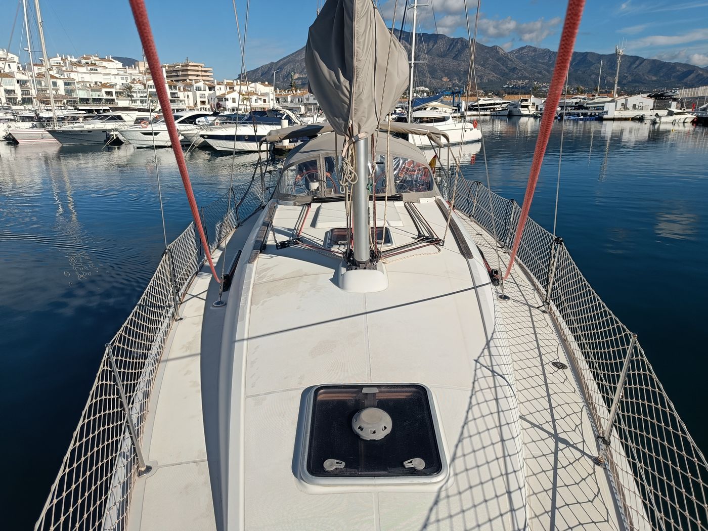 Guests on deck during a shared sailing trip from Puerto Banús, Marbella